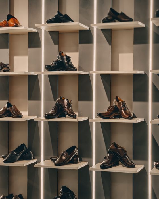Zapatos organizados en estantes tipo casilleros en una zapatería