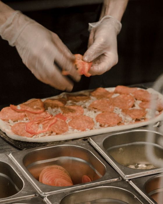Preparación de una pizza con ingredientes frescos